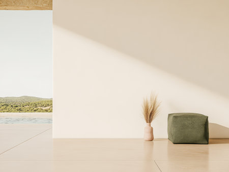 A serene corner showcases simple decor featuring a green cushion and a vase with dried grass framed by a beautiful outdoor landscape under clear blue skies.の素材
