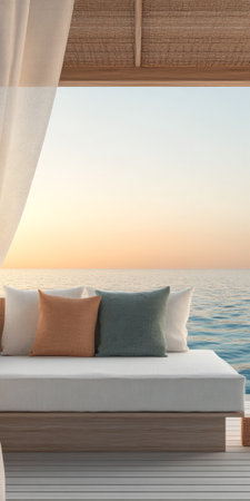 A tranquil lounge area featuring plush cushions overlooks a vast ocean as the sun sets on the horizon. The warm colors of dusk reflect beautifully on the water's surface creating a peaceful ambiance.の素材