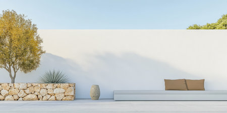 A serene outdoor setting showcases a minimalist design with a sleek stone bench and potted plants creating a tranquil atmosphere surrounded by a simple white wall and clear blue sky.の素材