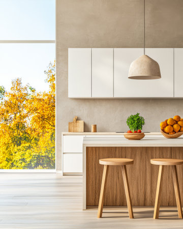 Bright and airy kitchen features a wooden island with stools a bowl of oranges and a vibrant view of autumn foliage through large glass windows.の素材
