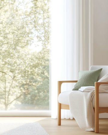 A bright living room features a contemporary white sofa adorned with a green pillow and a light throw. Large windows showcase a peaceful outdoor view filled with trees enhancing relaxation.の素材