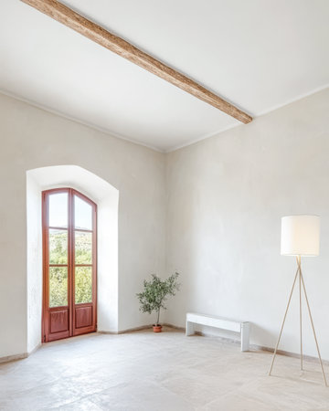 A spacious minimalist room features a large window allowing ample natural light. A simple wooden bench and a floor lamp enhance the serene atmosphere complemented by a small plant in a pot.の素材
