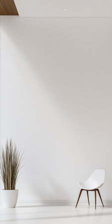 A minimalist room features a sleek white chair positioned beside a tall potted plant. Natural light pours in illuminating the clean lines and open space creating a serene atmosphere.の素材