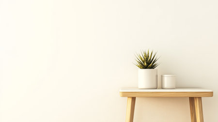 A wooden table holds a small potted plant alongside a white container. The background is a simple light-colored wall emphasizing the minimalist aesthetic of the arrangement.の素材