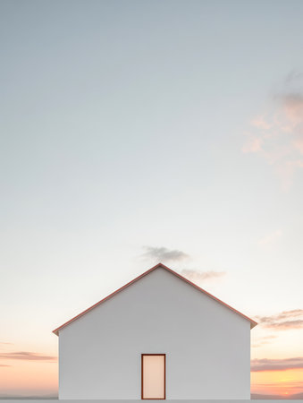 A minimalist white house with a sloped roof stands alone against a vast sky as the sun sets on the horizon creating a tranquil and peaceful atmosphere by the seaside.の素材