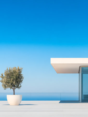 A sleek building overlooks the ocean featuring expansive glass walls and a minimalist design. A single olive tree in a large pot adds a touch of greenery to the tranquil environment.の素材