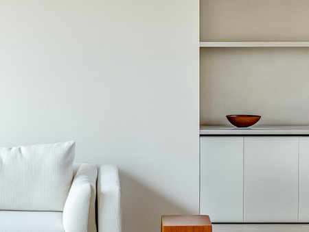 A spacious living room features a white sofa and wooden table highlighting minimalistic design with neutral tones. A bowl decorates the shelf emphasizing simplicity and elegance.の素材