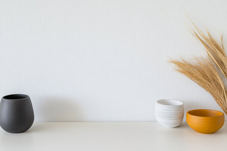 Minimalist decor showcases three stylish bowls in neutral colors alongside elegant dried grass. The setting highlights simplicity and contemporary design perfect for home styling.の素材
