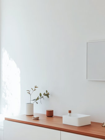 A minimalistic room features a wooden surface with decorative items a green plant in a white pot and soft sunlight illuminating the space creating a serene atmosphere.の素材