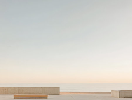 A serene beach landscape at dawn features soft pastel colors in the sky. Minimalistic benches line the shore inviting relaxation amidst the calming ocean waves.の素材
