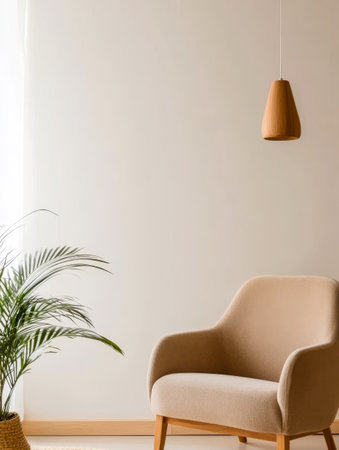 A cozy living room showcases a beige armchair next to a lush indoor plant. Natural light filters through a window enhancing the tranquil atmosphere of the space.の素材