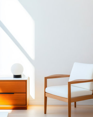 A bright living room showcases a wooden chair and bedside table gently illuminated by sunlight. The simple decor emphasizes clean lines and a serene atmosphere perfect for relaxation.の素材