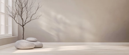 A minimalist room showcases a bare tree near a window with sunlight casting gentle shadows on smooth stones placed on a light wooden floor emphasizing simplicity and tranquility.の素材