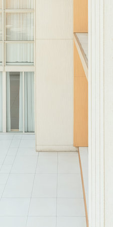 A spacious outdoor area showcases minimalist architecture featuring neutral tones and large glass windows. Soft curtains gently sway in the breeze enhancing tranquility.の素材