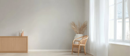 A bright living room showcases a minimalist design with soft natural light filtering through sheer curtains. A wicker chair is positioned near a large window enhancing the tranquil feel.の素材