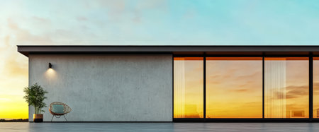 A sleek modern house showcases large sliding glass doors and a stylish chair on a smooth patio. The stunning sunset casts warm colors in the sky enhancing the tranquil atmosphere.の素材