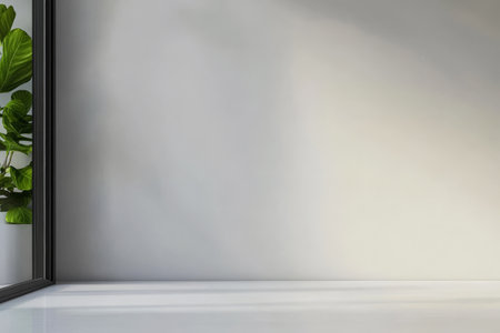 A bright and airy interior showcases a neutral-colored wall and a sleek surface. A vibrant green plant is visible through a large window enhancing the natural ambiance.の素材