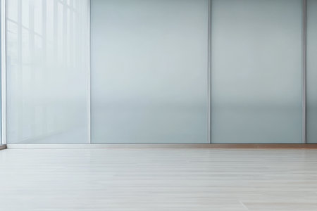 A spacious interior with sleek walls and polished wooden flooring features abundant natural light streaming through large windows. This design emphasizes simplicity and openness.の素材