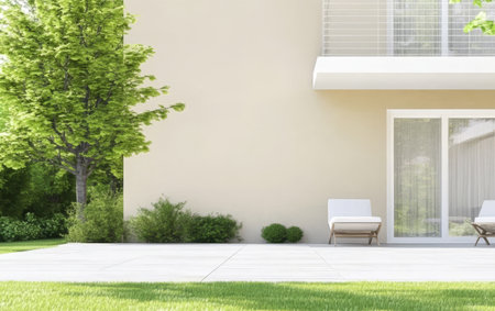 Bright outdoor space features two lounge chairs positioned on a tiled patio surrounded by lush greenery and shrubs, creating a tranquil retreat in a residential setting.の素材