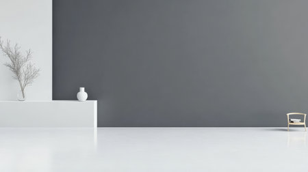 A spacious room features a minimalist design with a large gray wall, a white shelf displaying a vase, and a small chair. Natural light enhances the clean, contemporary atmosphere.の素材
