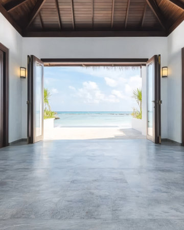 A spacious room with open doors overlooks a serene beach with clear blue water. The tropical setting invites relaxation, showcasing palm trees and soft sand just outside.の素材