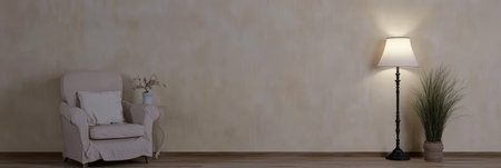 A comfortable chair is positioned next to a stylish floor lamp, creating a cozy atmosphere. The warm colors of the walls and the natural elements add a tranquil touch to the room.の素材