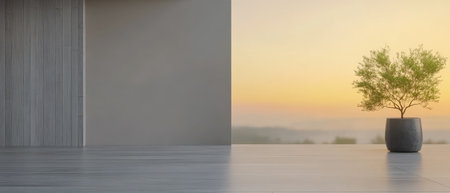 A spacious area features minimalist design elements and a large window that frames a beautiful sunset. An indoor plant sits in a stylish pot, enhancing the tranquil atmosphere.の素材