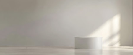 A spacious, minimalist room features a white pedestal in the center. Soft natural light filters through a nearby window, casting gentle shadows on the light-colored wooden floor.の素材