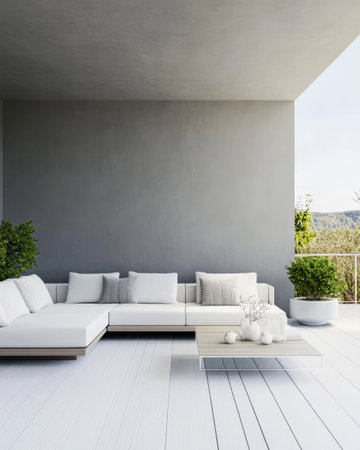 A spacious outdoor lounge area features a white sectional sofa and minimalist decor. The subtle gray walls and natural greenery create a tranquil atmosphere during daylight hours.の素材