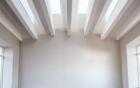 Sleek interior features a minimalist design with high, white-beamed ceilings and large windows that allow natural light to illuminate the space. The walls are softly painted in neutral tones.の素材