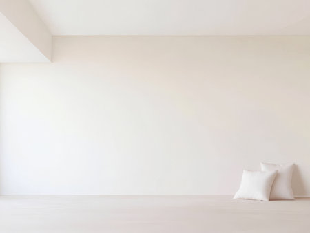 A spacious area showcases a clean, minimalist design with a bare white wall and soft white cushions placed on the light-colored floor, creating a serene atmosphere in a contemporary space.の素材