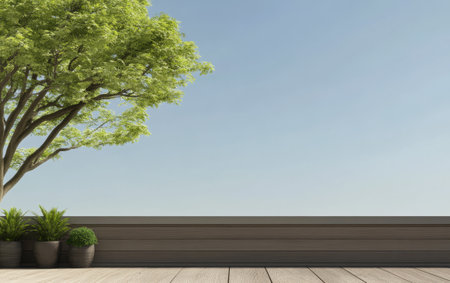 A tranquil outdoor setting features a wooden deck surrounded by lush green plants and a large tree under a clear blue sky. Ideal for relaxation or leisure activities in nature.の素材