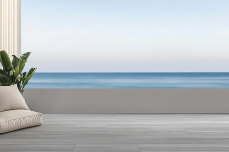A serene indoor space features a cozy seating area with soft cushions, overlooking a tranquil blue ocean. The room exudes calm, enhancing the peaceful atmosphere of the coastal view.の素材