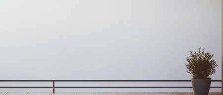 A modern indoor setting showcases a clean, minimalist design with a simple railing and a vibrant green plant in a pot. The light-colored wall adds brightness to the tranquil space, enhancing serenity.の素材