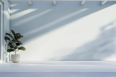 Bright, minimal space with a smooth white surface and a single potted plant. Sunlight creates gentle shadows, enhancing the calm ambiance. Perfect for relaxation or inspiration.の素材