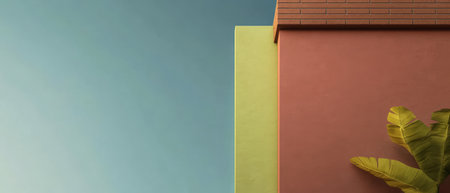 A colorful building corner features a blend of green and pink walls, set against a bright blue sky. Lush foliage adds to the vibrant atmosphere, highlighting modern design elements.の素材