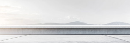 A smooth concrete surface stretches out, reflecting soft morning light. In the background, misty mountains create a serene landscape, inviting contemplation and relaxation.の素材