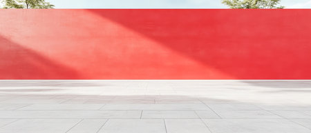 A striking red wall stands in a clean, open space surrounded by greenery. Soft shadows cast on the ground reveal the texture of the minimalist design during daylight.の素材