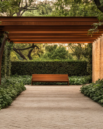 A serene atmosphere is created by a wooden bench positioned under a pergola in a garden. Surrounding greenery provides a peaceful setting, ideal for relaxation at golden hour.の素材