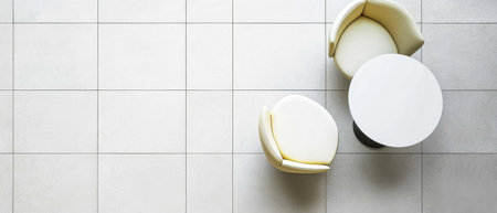 Soft rounded chairs accompany a sleek round table in a bright minimalistic space. The light-colored flooring enhances the inviting atmosphere ideal for conversation or relaxation.の素材
