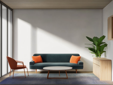 This contemporary living room showcases a teal sofa with orange cushions a stylish chair and a large plant all illuminated by sunlight streaming through a window.の素材