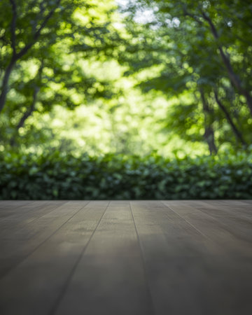 A wooden deck provides a peaceful vantage point to enjoy lush green trees and dense foliage. Sunlight filters through the leaves creating a tranquil atmosphere in nature.の素材