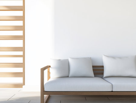 A spacious living room features a light gray sofa with plush cushions complemented by wooden accents and a bright airy atmosphere enhanced by natural light.の素材