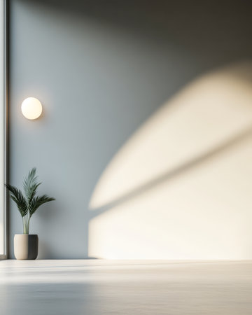 A spacious interior features a large window allowing soft natural light to fill the room. A simple plant sits in a pot enhancing the minimalist decor and creating a calming ambiance.の素材