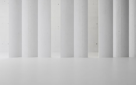 Bright and spacious room showcases a row of tall sleek white columns against a soft white background. The design emphasizes simplicity and open space creating a tranquil atmosphere.の素材