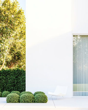 Bright sunlight illuminates a contemporary architectural design showcasing a white wall and large glass window. Lush green bushes create a serene outdoor atmosphere enhancing the inviting space.の素材