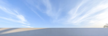 A beautiful expanse of blue sky filled with soft wispy clouds is visible in the late afternoon. The serene landscape beneath reflects the tranquil atmosphere of the moment.の素材