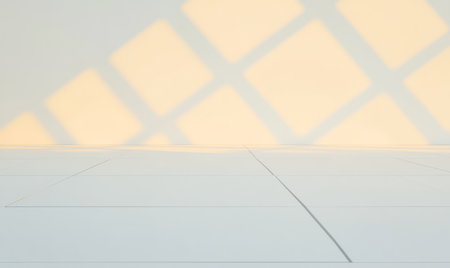Soft light filters through a window casting geometric shadows on a minimalistic white floor. The interplay of light and shadow creates a serene and artistic atmosphere.の素材