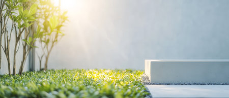 A tranquil outdoor area featuring lush green grass and plants complemented by soft sunlight illuminating the space. The minimalistic design enhances the peaceful ambiance.の素材