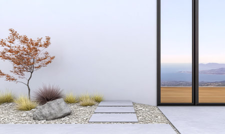 A contemporary garden features a minimalist design with a seasonal tree gravel paths and a large boulder. The backdrop offers a stunning view of the sea and mountains under a clear sky.の素材